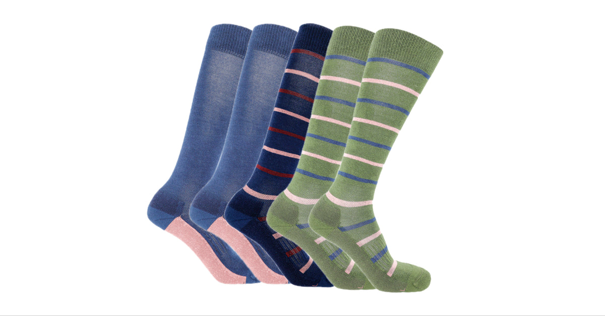 Five pairs of Soleberie Classic Long Socks arranged in a fan shape on a plain white background. The socks come in navy. navy stripe and green.