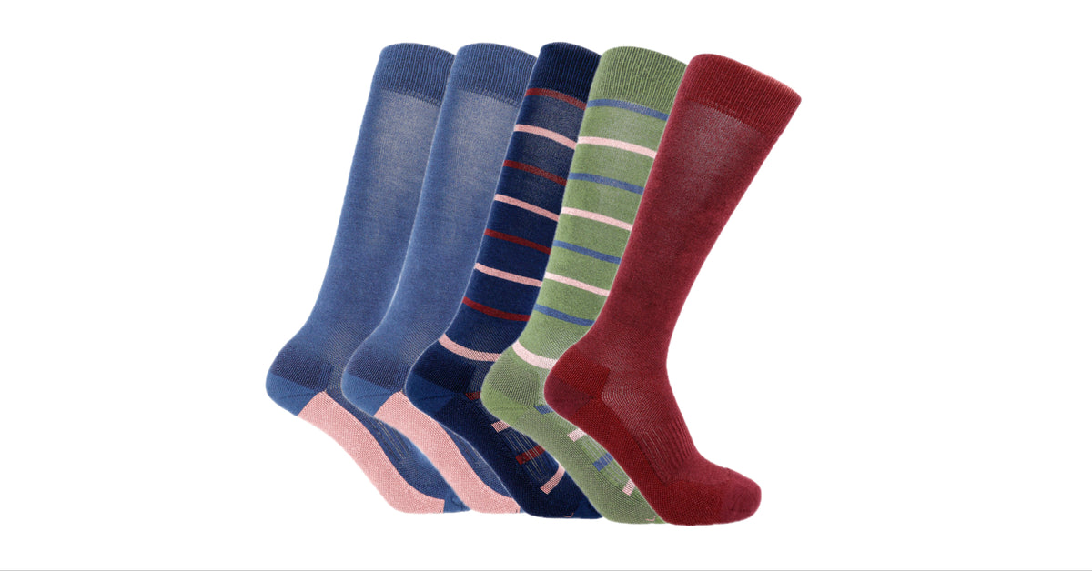 A set of five Soleberie Classic Long Socks in various colours and stripe patterns, including navy, green and burgundy, arranged in a fan shape against a plain white background.