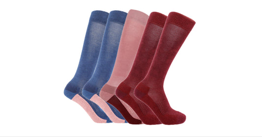Five Soleberie Classic Long Socks in navy, pink and burgundy, arranged in a fan shape against a plain white background.