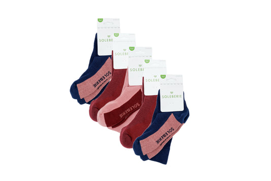 Five pairs of Soleberie ankle socks in navy, burgundy, and pink, arranged in a fan shape with their white paper header cards.